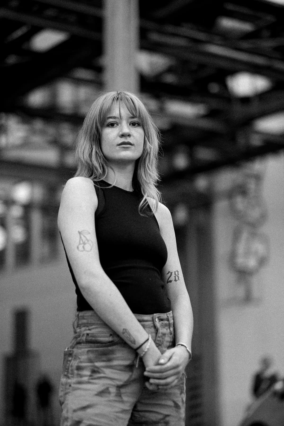 Black-and-white fashion portrait of a woman in a ribbed tank top
