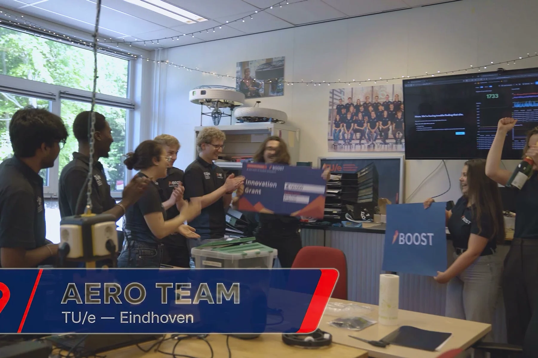 Aero Team Eindhoven celebrating with the Innovation Grant award in their workshop