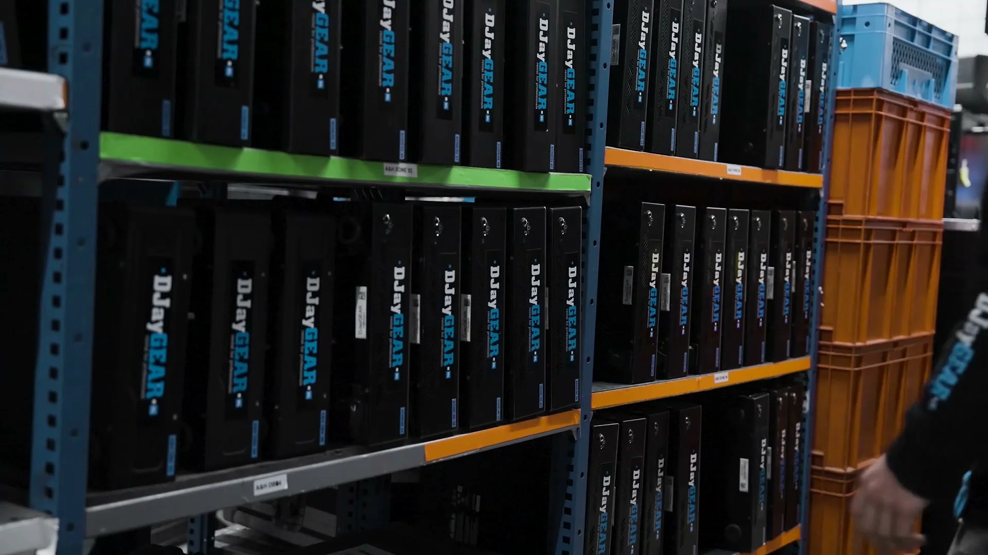 Rows of DJayGear flightcases stacked in the warehouse racks